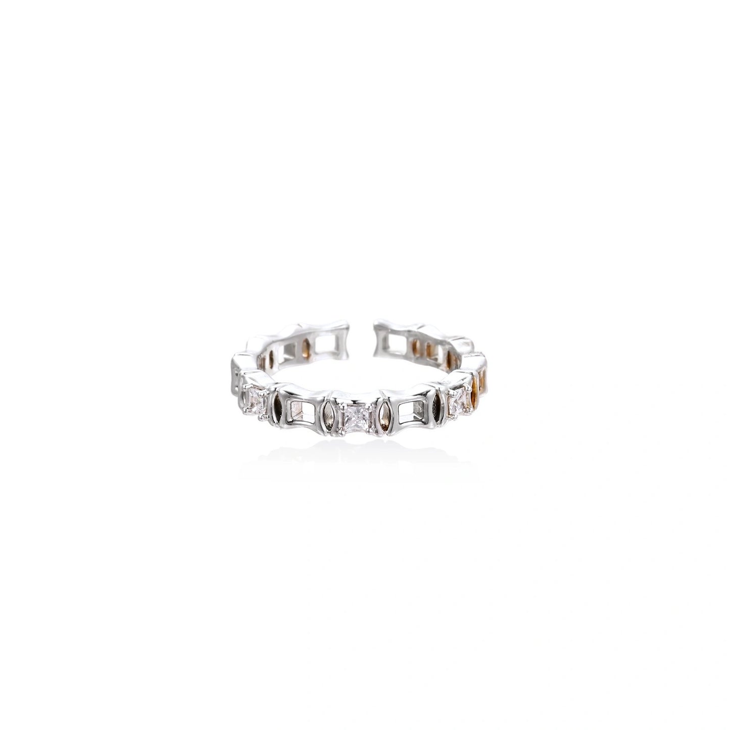 White gold plated ring with architectural lattice design and zirconia accents on cream background