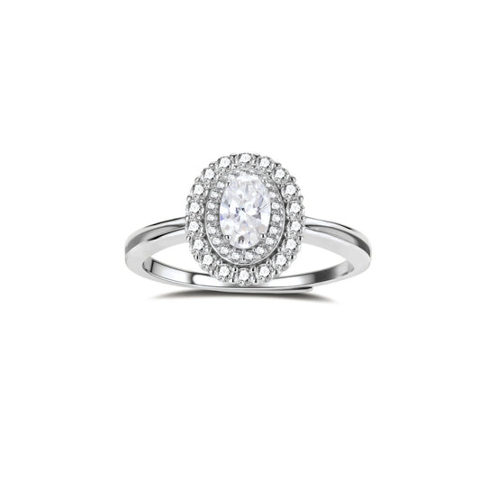 Sterling silver ring with oval moissanite center stone surrounded by double halo of sparkling stones on neutral background.