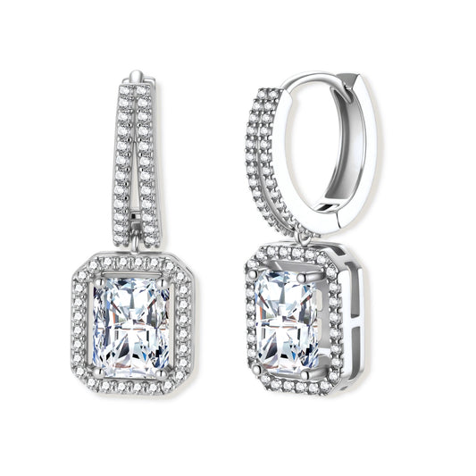 Sterling silver huggie hoops with emerald-cut moissanite drops featuring pavé-set crystals on white background.