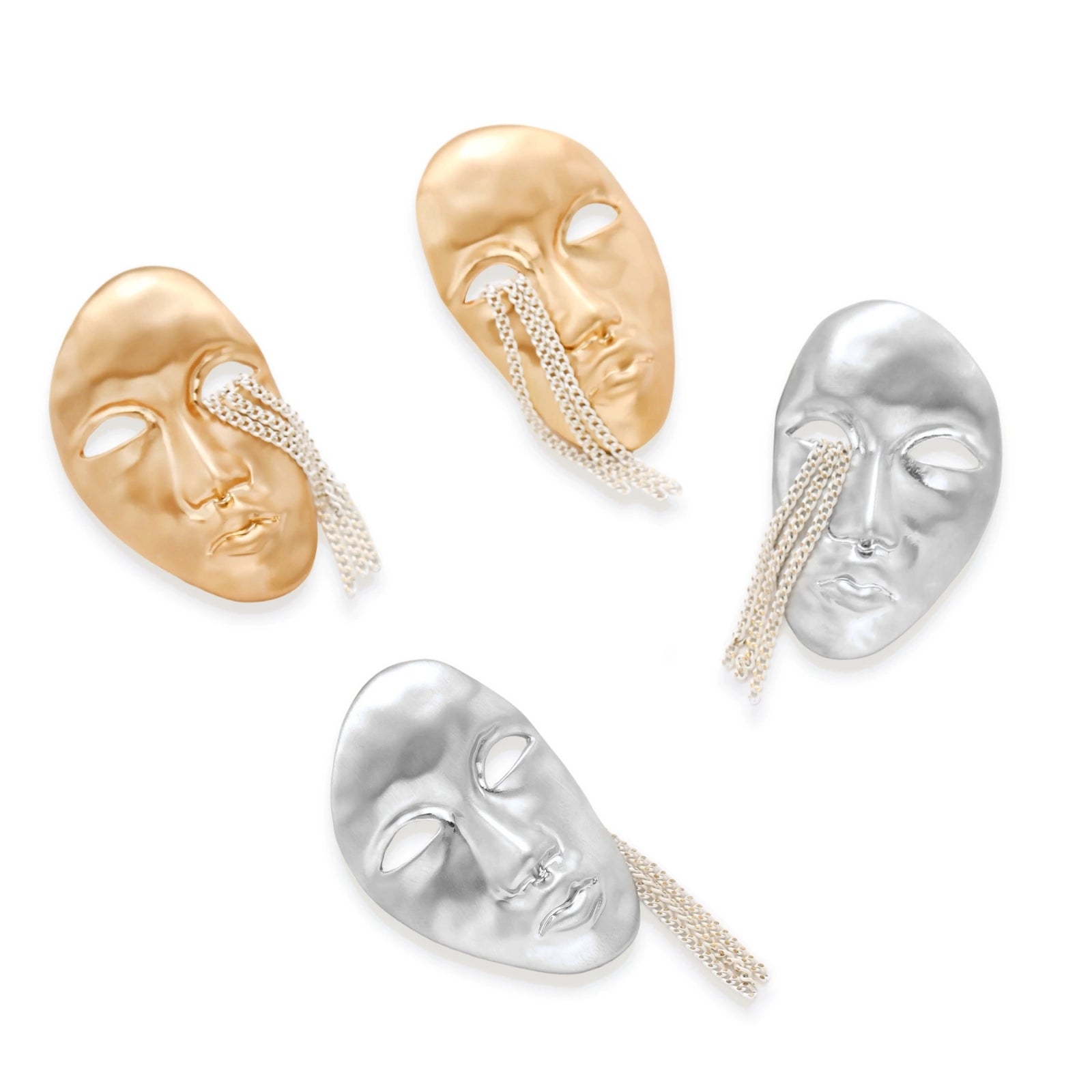 Gold-toned abstract face earrings with hollow eyes and chain details on white background, artistic statement jewelry