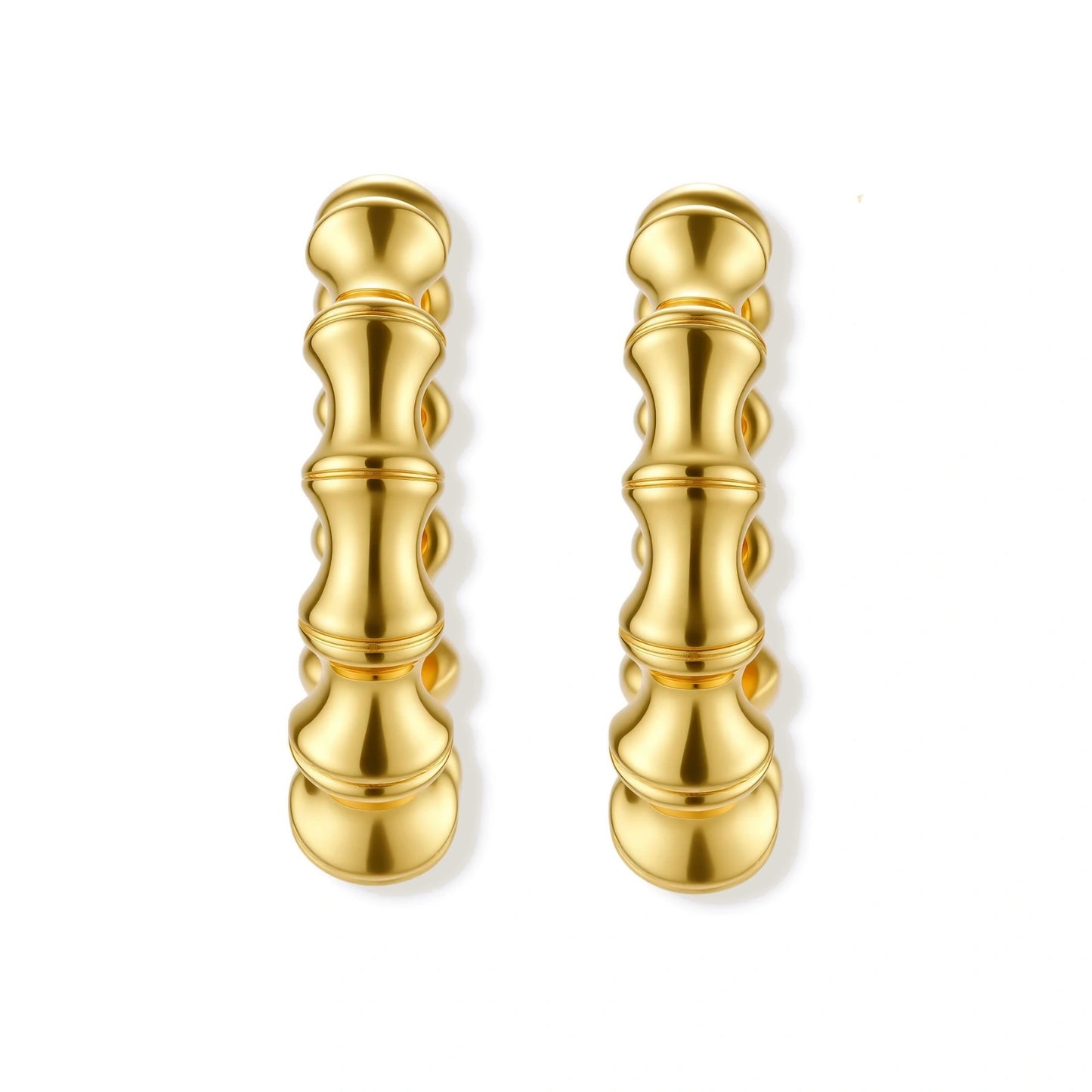 Close-up of gold-plated sterling silver hoop earrings with bamboo-inspired segmented design on white background.