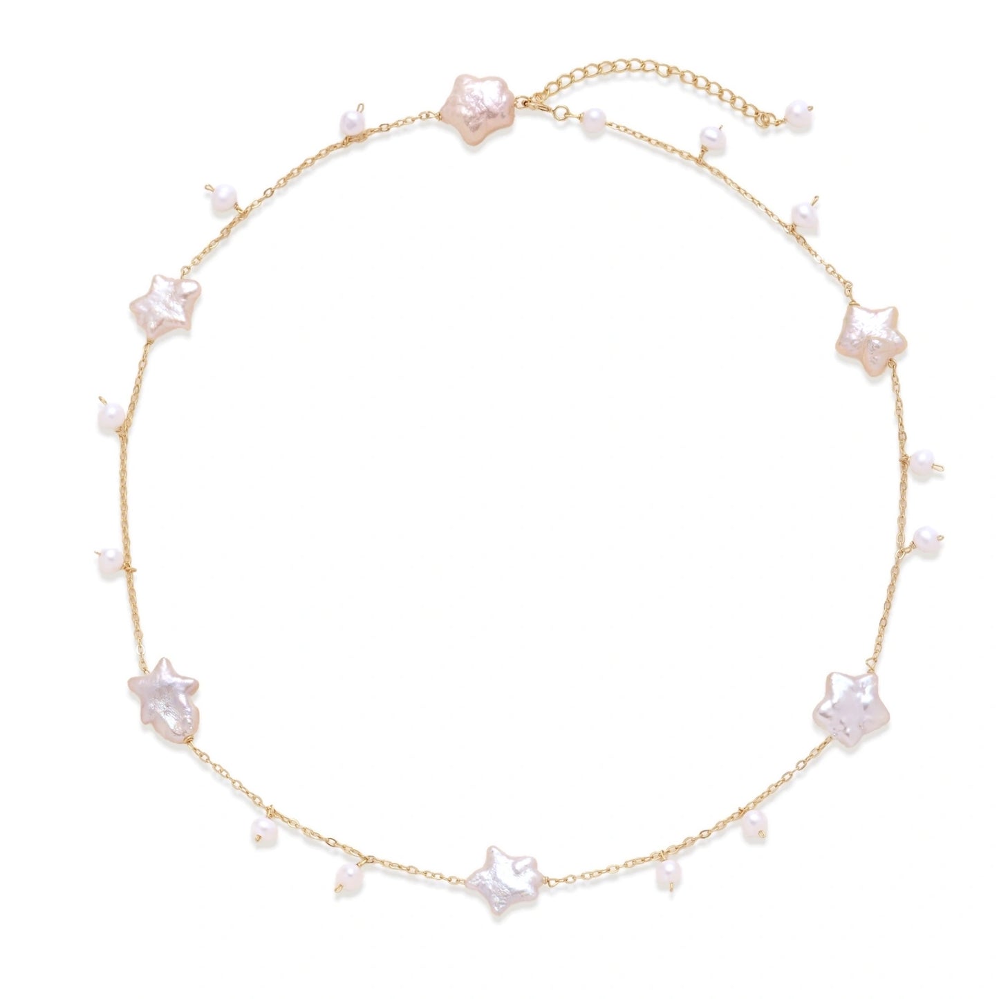 Gold vermeil chain with iridescent star-shaped baroque pearls and small round freshwater pearl drops on cream background.