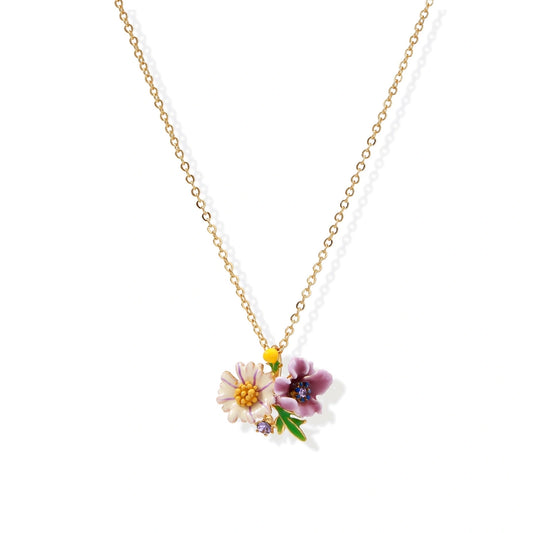 Gold-plated necklace with pink and purple enamel flower pendant featuring crystal accents on cream background