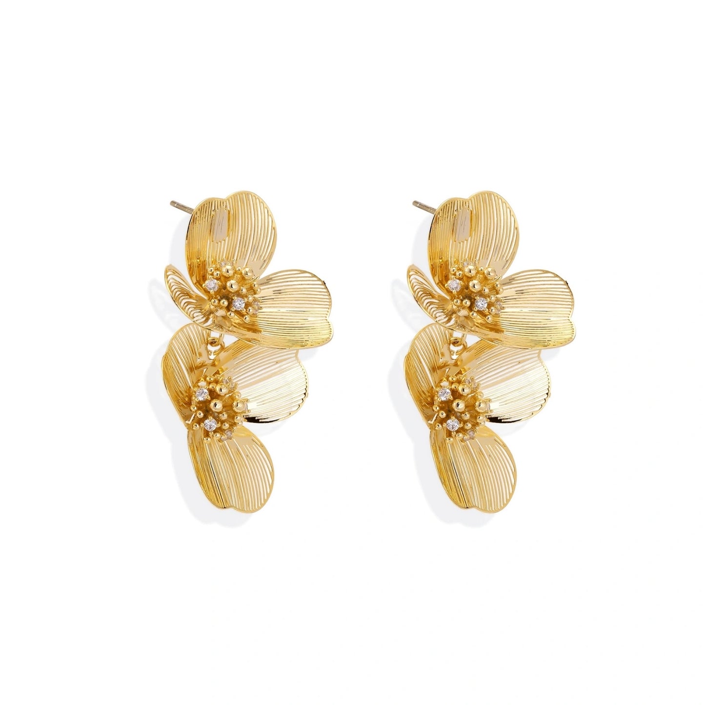 Pair of gold-plated double flower earrings with textured petals and crystal centers on cream background.