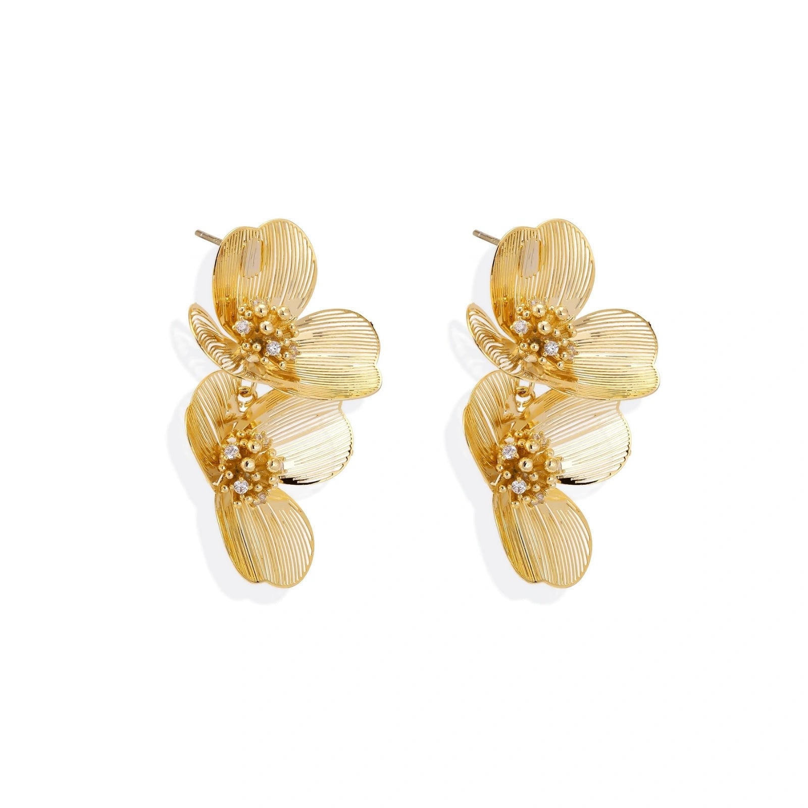 Pair of gold-plated double flower earrings with textured petals and crystal centers on cream background.