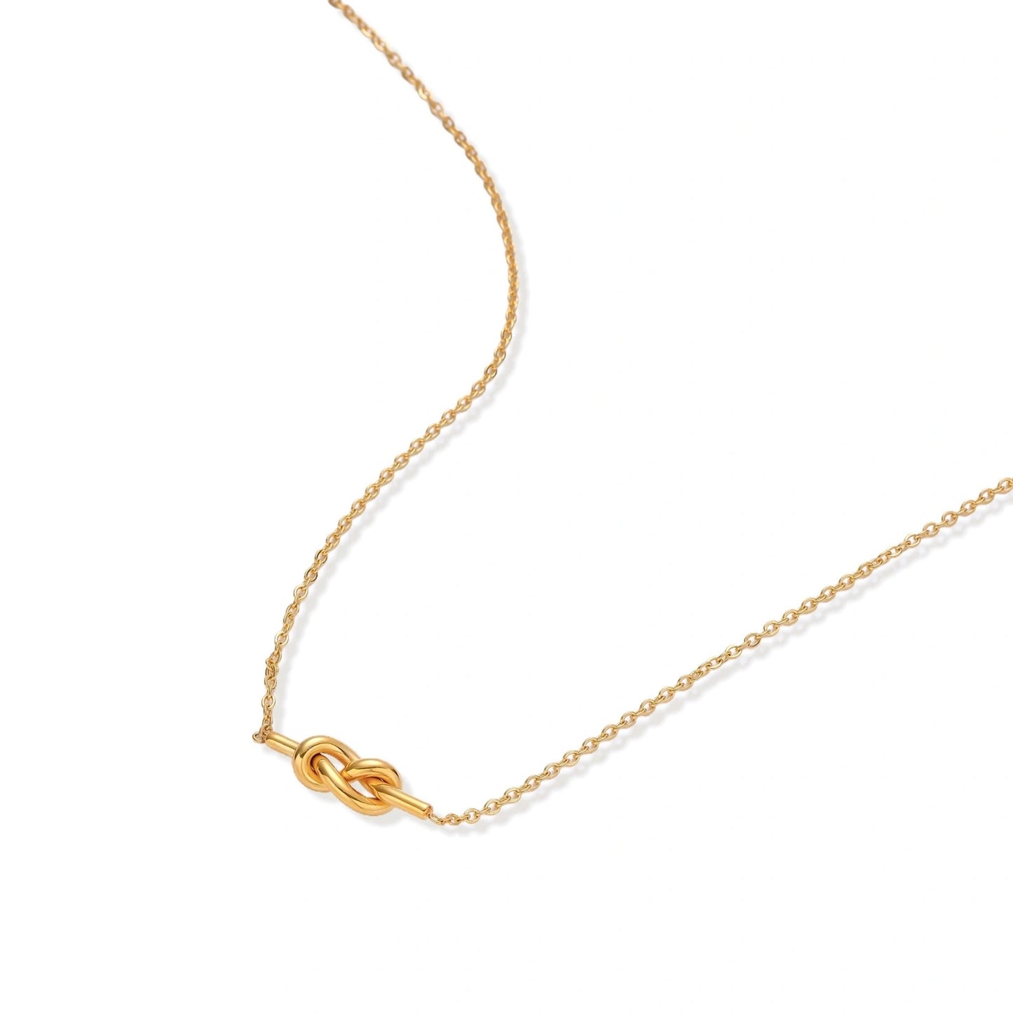 Dainty 18K gold plated necklace with infinity knot pendant on delicate chain against white background
