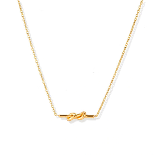Dainty 18K gold plated necklace with infinity knot pendant on delicate chain against white background