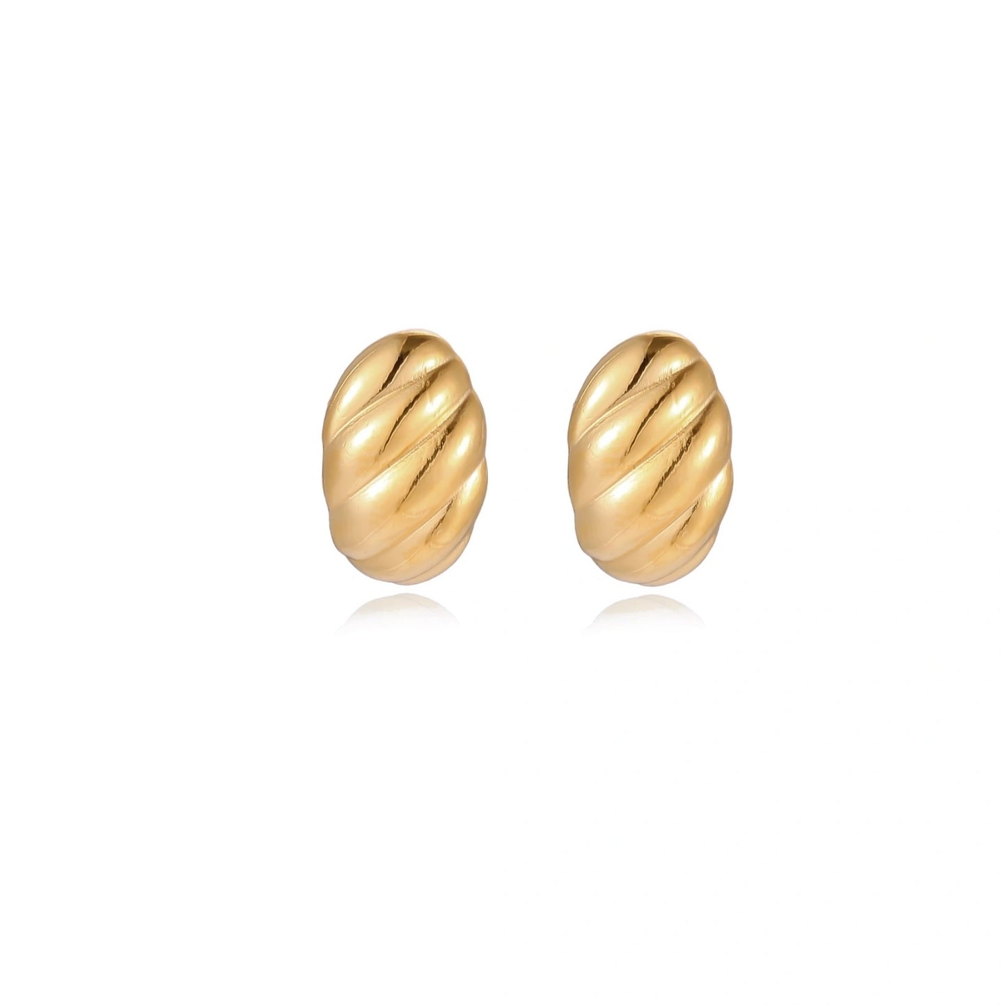 Chunky gold twisted rope huggie hoops with diagonal grooves and high-polish finish on cream background